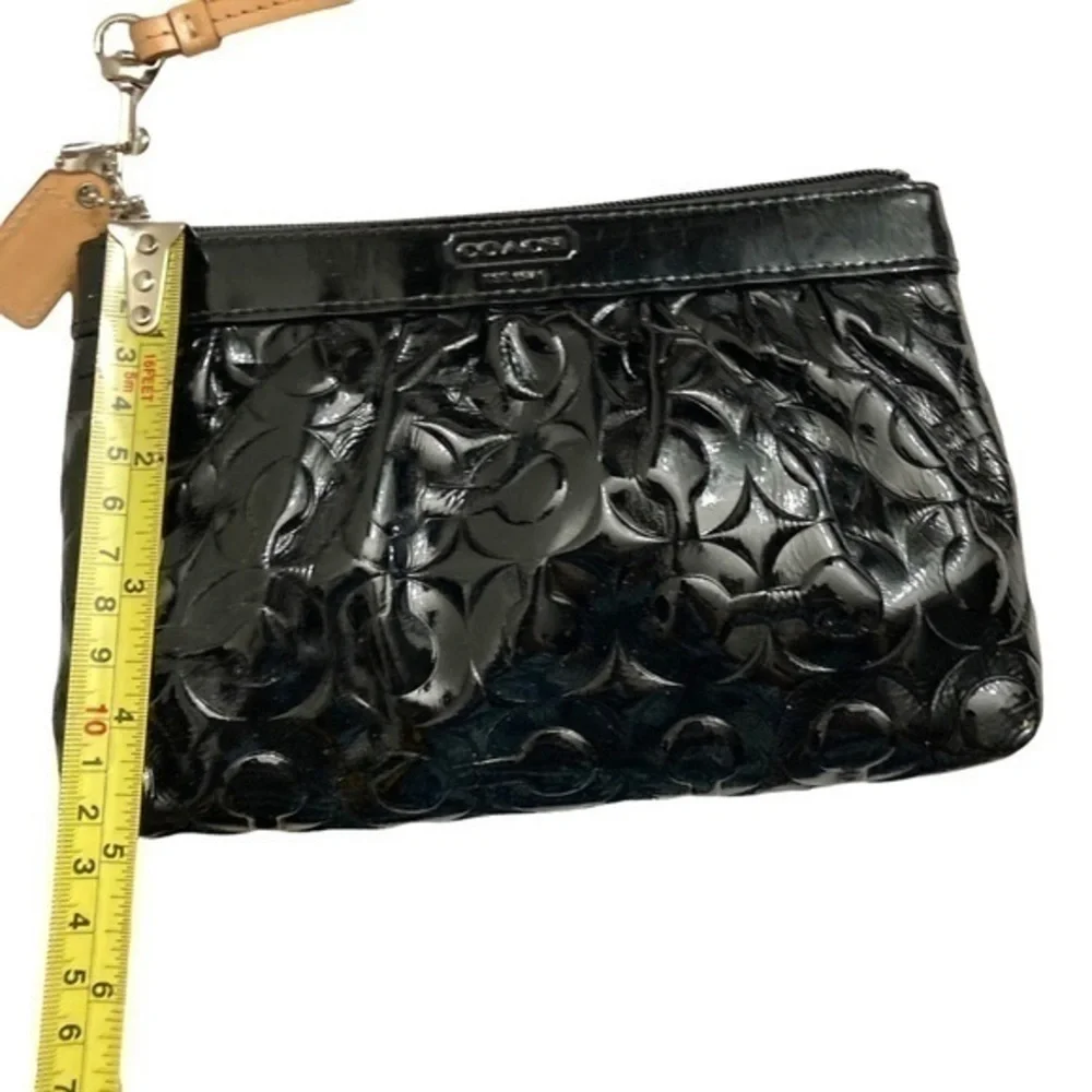 Coach embossed black patent leather op art wristlet bag